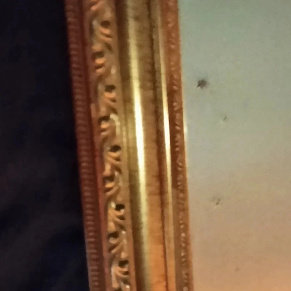 Gold framed wall mirror